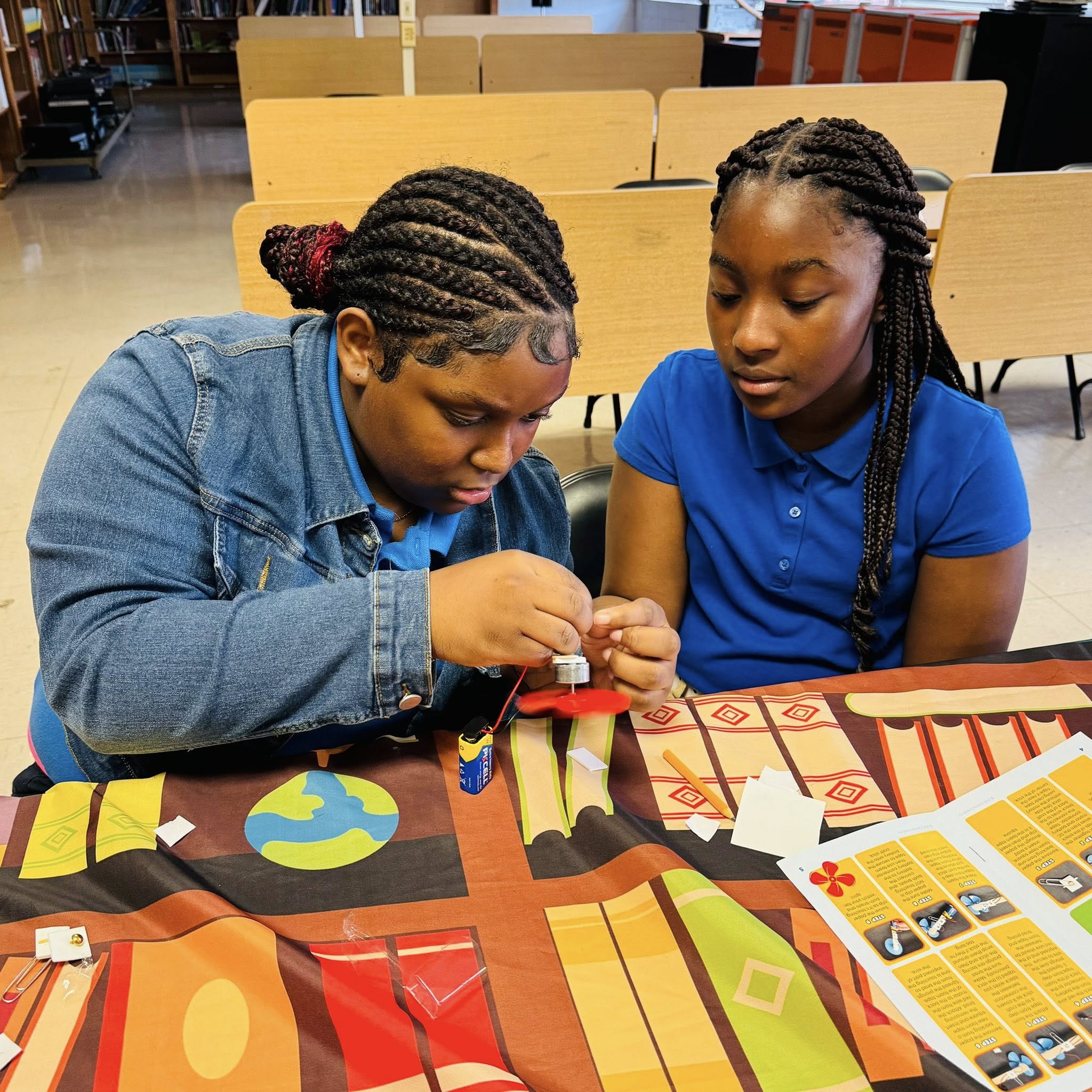 Two girls working on something.